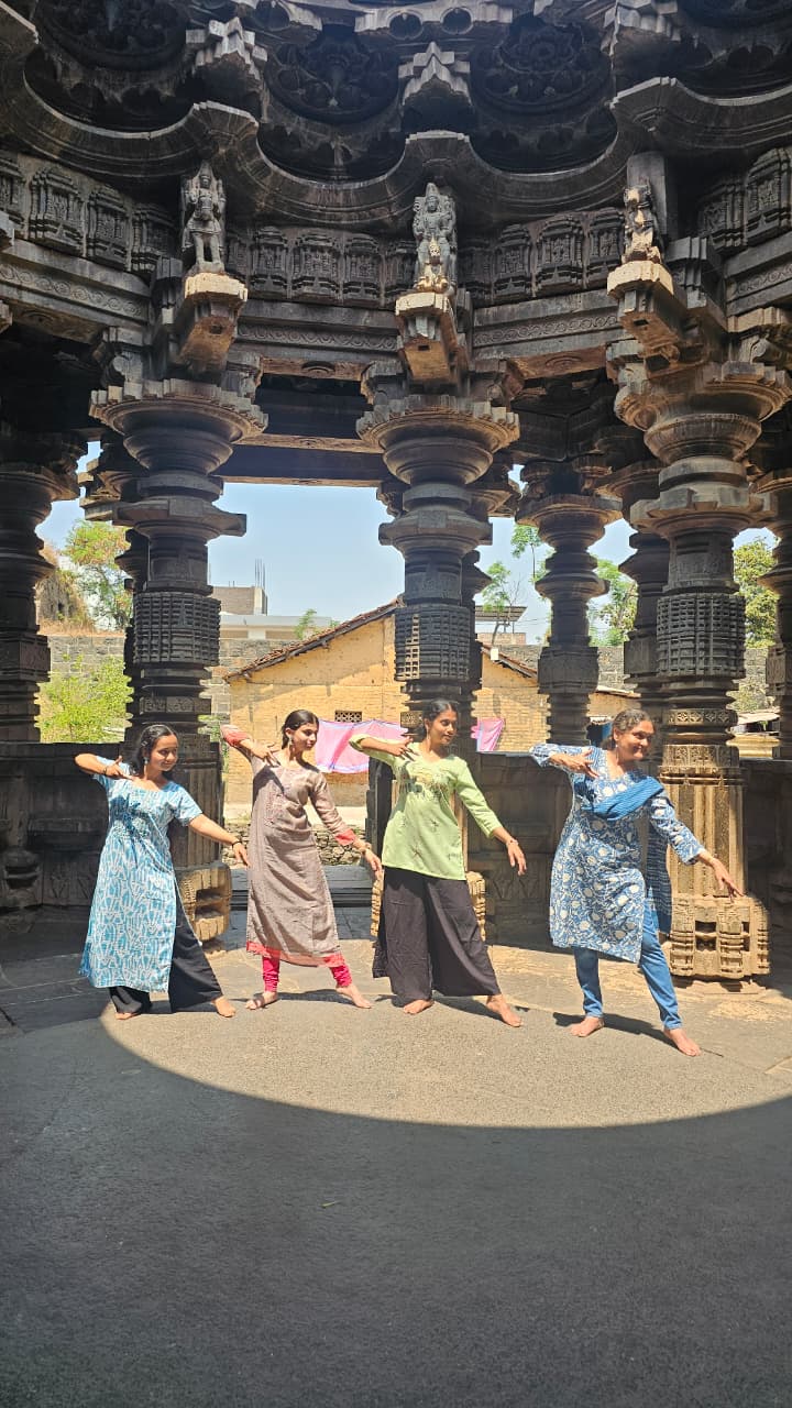 Young dancers posing in temple architecture